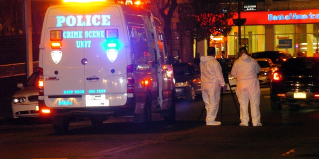 Police are investigating the deaths of a woman and two toddlers in the Queens borough of New York, Sunday, Jan. 19, 2014. Police say the bodies of a 1-year-old child, a 3-year-old child and a 21-year-old female were found in an apartment on Sutphin Blvd. in the Jamaica section of the borough. (AP Photo/David Torres)