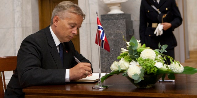 July 26: Norwegian minister of Justice, Knut Storberget, signs a protocol of condolence for the victims of last Friday's bomb attack and shooting massacre, in the Grand Hall of Oslo University.
