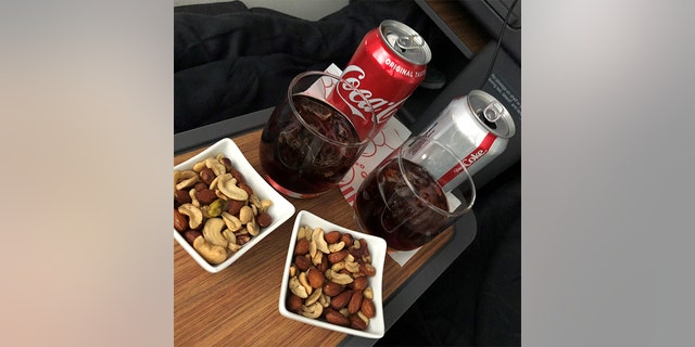 The drinks and nuts served on the American Airlines flight.
