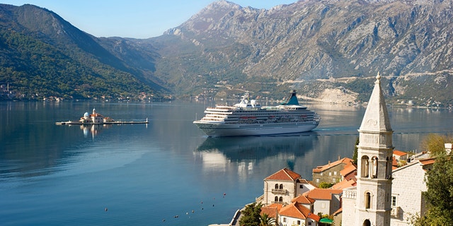 Aerial view on town Perast with Church "Our Lady of the rocks" and cruise liner. Montenegro