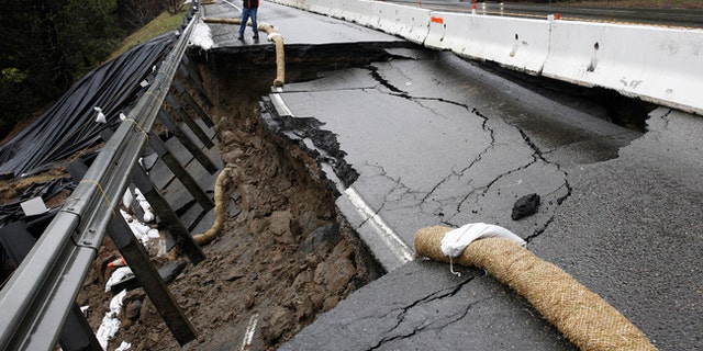 The shoulder and one lane of westbound Highway 50 are damaged due to storms near Pollock Pines, Calif.