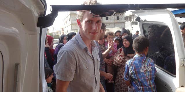 This undated photo provided by the Kassig family shows Peter Kassig delivering supplies for Syrian refugees.