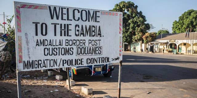 A sign at the border crossing between Gambia and Senegal near the town of Karang, Senegal, Thursday, Jan. 19, 2017. Gambia's president-elect said Thursday he will be sworn into office at the Gambian Embassy in neighboring Senegal, while there was no word from longtime leader Yahya Jammeh on the day that his mandate expired. (AP Photo/Sylvain Cherkaoui)