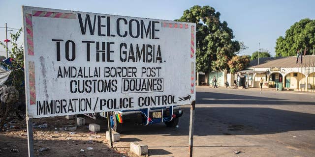 A sign at the border crossing between Gambia and Senegal near the town of Karang, Senegal, Thursday, Jan. 19, 2017. Gambia's president-elect said Thursday he will be sworn into office at the Gambian Embassy in neighboring Senegal, while there was no word from longtime leader Yahya Jammeh on the day that his mandate expired. (AP Photo/Sylvain Cherkaoui)
