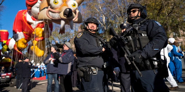 Heavily-armed members of the New York Police Department take a position along the route before the start of the Macy's Thanksgiving Day Parade in New York, Thursday, Nov. 23, 2017.