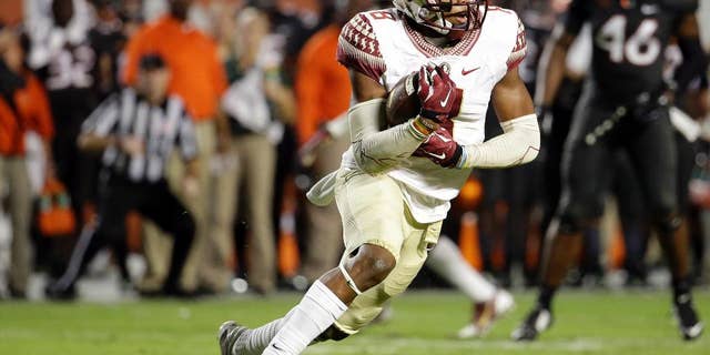 Florida State defensive back Jalen Ramsey runs with the ball after intercepting a pass thrown by Miami quarterback Brad Kaaya in the second half an NCAA college football game, Saturday, Nov. 15, 2014, in Miami Gardens, Fla. Florida State defeated Miami 30-26. (AP Photo/Lynne Sladky)
