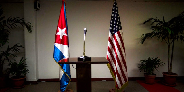 FILE - In this Jan. 22, 2015 file photo, Cuban and U.S. flags stand before the start of a press conference on the sidelines of talks between the two nations in Havana, Cuba. Members of the U.S. Democratic congressional delegation to Cuba said on Tuesday, Feb. 17, 2015 the next round of negotiations on restoring full diplomatic ties with Cuba will take place in Washington next week. (AP Photo/Ramon Espinosa, File)