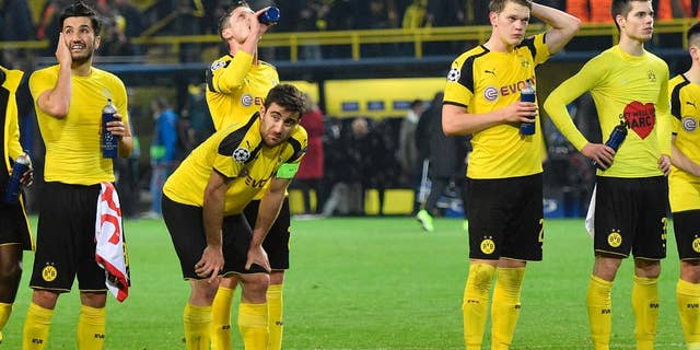 Dortmund's Nuri Sahin, Sokratis Papastathopoulos, Lukasz Piszczek, Matthias Ginter and Julian Weigl, from left, react after losing 2-3 during the Champions League quarterfinal first leg soccer match between Borussia Dortmund and AS Monaco in Dortmund, Germany, Wednesday, April 12, 2017. (AP Photo/Martin Meissner)