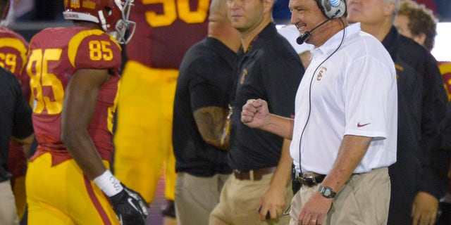 Southern California interim coach Ed Orgeron, right, celebrates after USC scored a touchdown during the first half of an NCAA college football game against Arizona, Thursday, Oct. 10, 2013, in Los Angeles. (AP Photo/Mark J. Terrill)