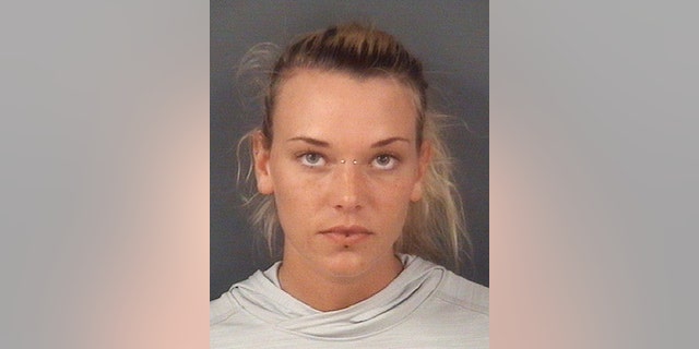 In this undated photo released by the Cumberland County Sheriff's Office, in Fayetteville, N.C., Marinna Rollins, poses for a photo. Rollins was arrested Tuesday, April 25, 2017, and charged with cruelty to animals. The veteran has been charged with tying her service dog to a tree and shooting it five times while a soldier filmed it. (Cumberland County Sheriff's Office via AP)