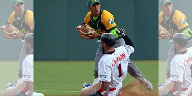 Cuba's Dainer Moreira, facing the camera, during a game in San Juan, Puerto Rico, Tuesday, Feb. 3, 2015.