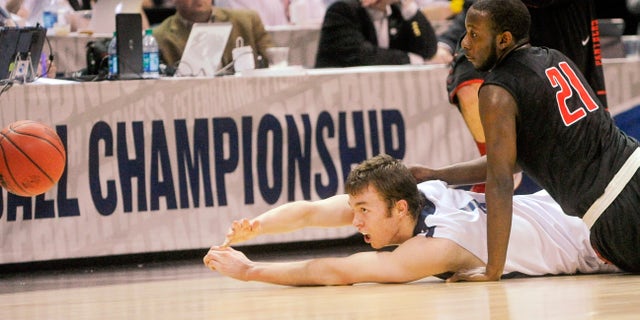 Metro State center Nicholas Kay passes from the floor as Drury guard Brandon Lockhart (21) defends during the first half of the NCAA Division ll national championship basketball game Sunday April 7, 2013, in Atlanta. (AP Photo/John Amis)