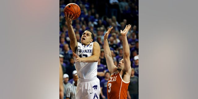 Kansas State guard Angel Rodriguez (13) gets past Texas guard Javan Felix (3) for a basket during the second half of an NCAA college basketball game in Manhattan, Kan., Wednesday, Jan. 30, 2013. Kansas State defeated Texas 83-57. (AP Photo/Orlin Wagner)