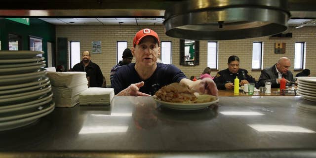 In this Jan. 23, 2015 photo, Mark Childers grabs a turkey reuben sandwich to deliver to a customer at the Superior Restaurant Friday, in Cleveland. The Labor Department reports on state unemployment rates for January on Tuesday, March 17, 2015. (AP Photo/Tony Dejak)