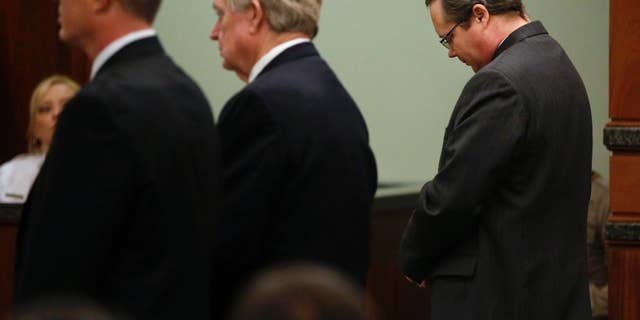 Eric Williams lowers his head as a guilty verdict is read during his capital murder trial at the Rockwall County Courthouse in Rockwall, Texas, on Thursday, Dec. 4, 2014. The jury convicted Williams, a former public official, in the 2013 murder of Cynthia McLelland and her husband Kaufman County District Attorney Mike McLelland. Williams now faces a potential death sentence. (AP Photo/The Dallas Morning News, Pool)