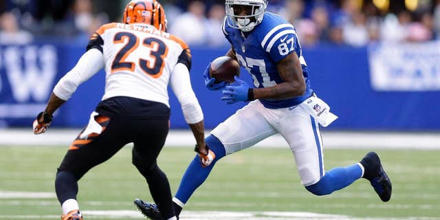 Indianapolis Colts wide receiver Reggie Wayne (87) runs against Cincinnati Bengals cornerback Terence Newman (23) during the second half of an NFL football game Sunday, Oct. 19, 2014, in Indianapolis. (AP Photo/Michael Conroy)