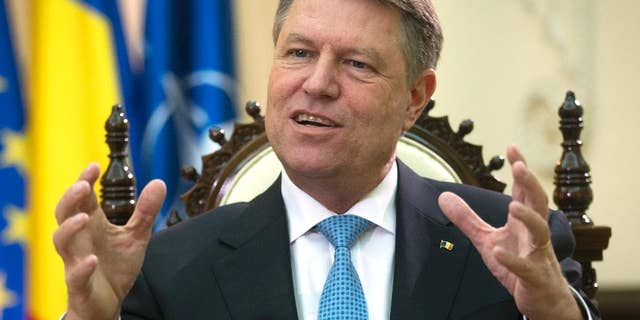 Romania's president Klaus Iohannis gestures during an interview with the Associated Press at the Cotroceni Palace in Bucharest, Romania, Wednesday, Feb. 8, 2017. President Iohannis said massive street protests had successfully toppled a government initiative dilute the ant-corruption drive, but warned that the fight against graft was an ongoing process. (AP Photo/Darko Bandic)