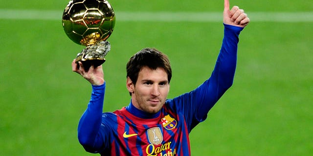 FILE - Messi holds his Ballon d'Or (Golden Ball) award as European Footballer of the Year before a Spanish La Liga soccer match between FC Barcelona and Betis at the Camp Nou stadium in Barcelona, Spain, Sunday, Jan. 15, 2012. (AP Photo/Manu Fernandez)