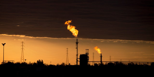 In this Feb. 18, 2015 photo, flames burn at an oil complex near El Tigre, a town located within Venezuela's Hugo Chavez oil belt, formally known as the Orinoco Belt. The Costa Rica-sized area is home to the worlds largest oil reserves and about half of Venezuelas current production. (AP Photo/Fernando Llano)