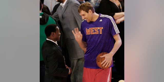 Former NBA player Avery Johnson, left speaks with West Team's Dirk Nowitzki, of the Dallas Mavericks (41) before the NBA All Star basketball game, Sunday, Feb. 16, 2014, in New Orleans. (AP Photo/Bill Haber)