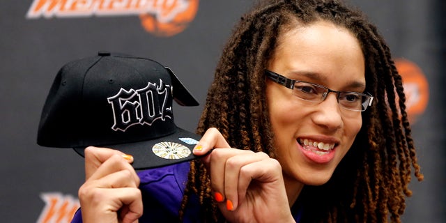 FILEm - In this April 20, 2013 file photo, Phoenix Mercury's Brittney Griner, the No. 1 overall pick the WNBA draft, holds up a hat during a news conference in in Phoenix. Long, athletic, dominating at both ends of the floor, the Mercury's rookie center has the kind of star power that can reach well beyond her 7-foot-4 wingspan. (AP Photo/Matt York, File)