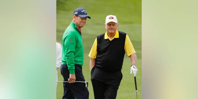 Tom Watson, left, talks to Jack Nicklaus on the second hole during the par three competition at the Masters golf tournament Wednesday, April 6, 2016, in Augusta, Ga. (AP Photo/Chris Carlson)