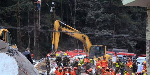 Rescuers search for survivors at the site of collapsed homes in Dahui village, Baizhangji township in Wencheng county in east China's Zhejiang province, Thursday, Feb. 2, 2017. Several people were buried in the collapse of a group of homes in eastern China on Thursday morning, a Chinese rescue official and state media reported. (Chinatopix via AP)