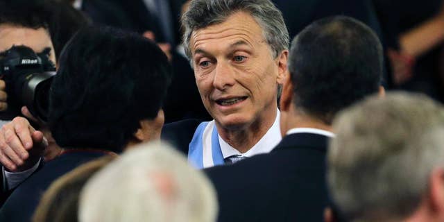 Argentina's President Mauricio Macri, center, meets Bolivia's President Evo Morales, left, and Ecuador's President Rafael Correa, right, after receiving the presidential sash at the government house in Buenos Aires, Argentina, Thursday, Dec. 10, 2015. Macri, the former mayor of Buenos Aires who hails from one of Argentina's richest families, took the oath of office in Congress in front of legislators, several Latin American heads of state and other dignitaries. (AP Photo/Victor R. Caivano)