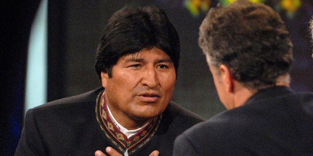 Bolivian President Evo Morales, left, speaks with Daily Show host Jon Stewart, center, on Comedy Central's "The Daily Show with Jon Stewart" in New York, Tuesday Sept. 25, 2007. Morales's translator is seen at right. (AP Photo/Peter Kramer)