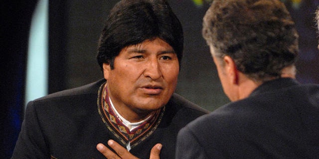 Bolivian President Evo Morales, left, speaks with Daily Show host Jon Stewart, center, on Comedy Central's "The Daily Show with Jon Stewart" in New York, Tuesday Sept. 25, 2007. Morales's translator is seen at right. (AP Photo/Peter Kramer)