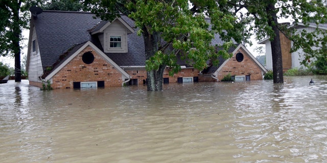 A home surrounded by floodwaters from Harvey on Monday.