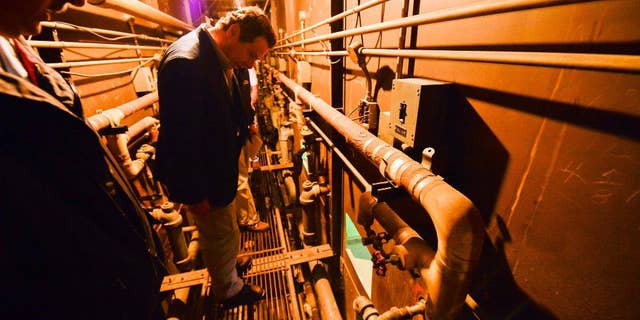 This photo provided by New York State Governor's office shows Gov. Andrew Cuomo on a catwalk looking into the cell that inmates escaped from at a maximum-security prison near the Canadian border in Dannemora, N.Y.