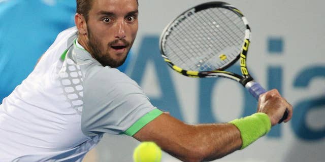 Viktor Troicki of Serbia plays a shot in the men's final against Mikhail Kukushkin of Kazakhstan at the Sydney International Tennis tournament in Sydney, Saturday, Jan. 17, 2015. (AP Photo/Rob Griffith)