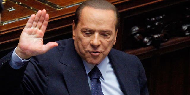 Italian Premier Silvio Berlusconi gestures in the Lower Chamber, in Rome, Friday, Oct. 14, 2011.