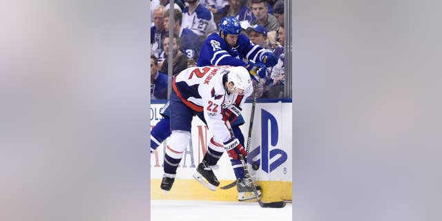 Toronto Maple Leafs left wing Matt Martin (15) hits Washington Capitals defenseman Kevin Shattenkirk (22) during the second period of Game 6 of an NHL hockey Stanley Cup first-round playoff series in Toronto on Sunday, April 23, 2017. (Nathan Denette/The Canadian Press via AP)