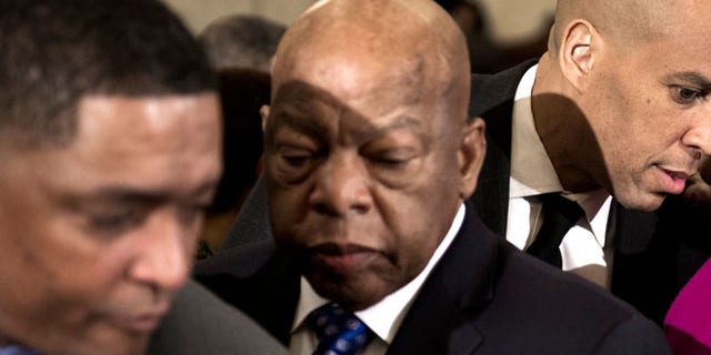 Jan. 11: Rep. John Lewis, D-Ga., center, takes a seat at the witness table on Capitol Hill in Washington.