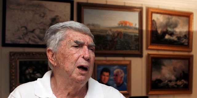 In this photo taken Nov. 8, 2010, Luis Posada Carriles talks to a reporter in Miami. As he prepares for trial Monday, Jan. 10, 2011 in El Paso, Texas, on federal charges connected to the decade-old bombings that killed an Italian tourist, Posada's art says much about the cagey former CIA asset who remains a lightning rod in much of Latin America. (AP Photo/Alan Diaz)