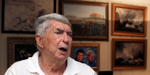 In this photo taken Nov. 8, 2010, Luis Posada Carriles talks to a reporter in Miami. As he prepares for trial Monday, Jan. 10, 2011 in El Paso, Texas, on federal charges connected to the decade-old bombings that killed an Italian tourist, Posada's art says much about the cagey former CIA asset who remains a lightning rod in much of Latin America. (AP Photo/Alan Diaz)