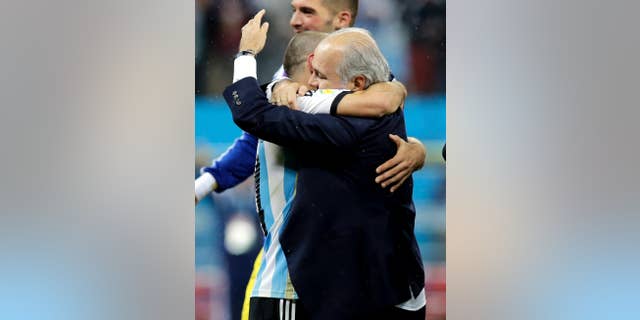 Argentina's head coach Alejandro Sabella, right, hugs Javier Mascherano after Argentina defeated the Netherlands 4-2 in a penalty shootout after a 0-0 tie after extra time to advance to the finals during the World Cup semifinal soccer match between the Netherlands and Argentina at the Itaquerao Stadium in Sao Paulo Brazil, Wednesday, July 9, 2014. (AP Photo/Victor R. Caivano)
