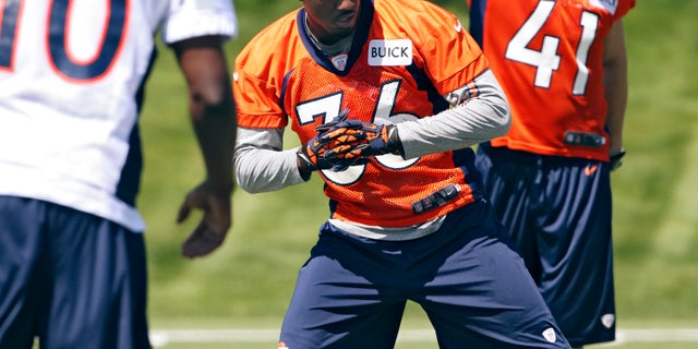 Denver Broncos cornerback Kayvon Webster (36) stretches with teammates Gerell Robinson (10) and Ross Rasner (41) during NFL football rookie minicamp at the team's training facility in Englewood, Colo., Saturday, May 11, 2013. (AP Photo/Ed Andrieski)