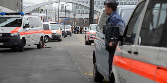 Police cars wait outside the Zurich, Switzerland, university of art Thursday morning Dec. 4, 2014 after an alarm was given. Police wasn't able to immediately give the reason for the alarm. (AP Photo/Keystone, Walter Bieri)