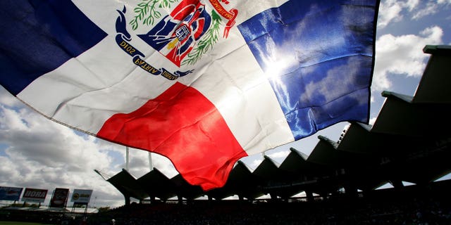 SAN JUAN, PUERTO RICO - MARCH 13: A fan flies the Dominican Republic flag during the game against Cuba during Round 2 of the World Baseball Classic on March 13, 2006 at Hiram Bithorn Stadium in San Juan, Puerto Rico. (Photo by Al Bello/Getty Images)