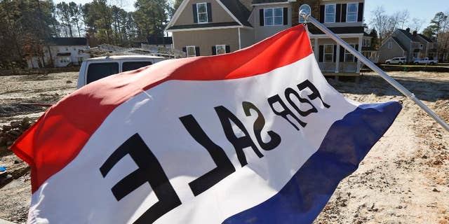 In this Jan. 8, 2015 photo, a flag advertising a new home for sale flaps in the breeze in Richmond, Va. The Commerce Department reports on U.S. sales of new homes in January on Wednesday, Feb. 25, 2015. (AP Photo/Steve Helber)