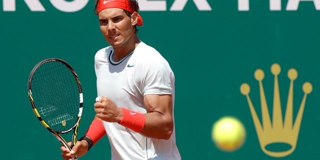 Spain's Rafael Nadal reacts during his match against Philipp Kohlschreiber of Germany at the Monte Carlo Tennis Masters tournament in Monaco, Thursday, April 18, 2013. (AP Photo/Lionel Cironneau)