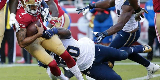 San Francisco 49ers quarterback Colin Kaepernick (7) is sacked by St. Louis Rams defensive tackle Michael Brockers during the fourth quarter of an NFL football game in Santa Clara, Calif., Sunday, Nov. 2, 2014. (AP Photo/Marcio Jose Sanchez)