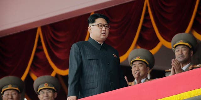 North Korean leader Kim Jong Un, center, watches parade participants from a balcony at the Kim Il Sung Square on Tuesday, May 10, 2016, in Pyongyang, North Korea. Hundreds of thousands of North Koreans celebrated the country's newly completed ruling-party congress with a massive civilian parade featuring floats bearing patriotic slogans and marchers with flags and pompoms. (AP Photo/Wong Maye-E)