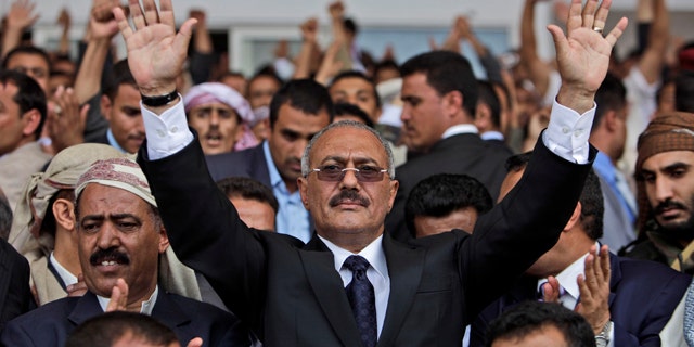 April 15: Yemeni President Ali Abdullah Saleh waves to his supporters during a rally in Sanaa, Yemen.