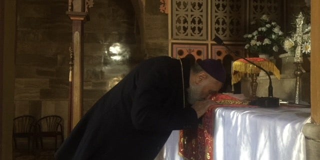 Father Afram at St. George Cathedral, outside of Mosul City.