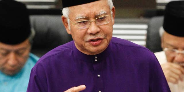 FILE - In this Oct. 23, 2015 file photo, Malaysian Prime Minister and Finance Minister Najib Razak speaks as he unveils the Malaysia's 2016 budget at Parliament House in Kuala Lumpur, Malaysia. Scandal-ridden Najib is seeking a big win for his ruling coalition in elections in the country's biggest state. More than 1.1 million people in Sarawak state on Borneo island are voting Saturday, May 7, 2016, for 82 lawmakers in the state assembly. (AP Photo/Joshua Paul, File)