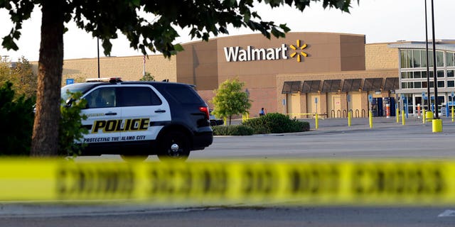 San Antonio police officers investigate the scene at the Walmart.